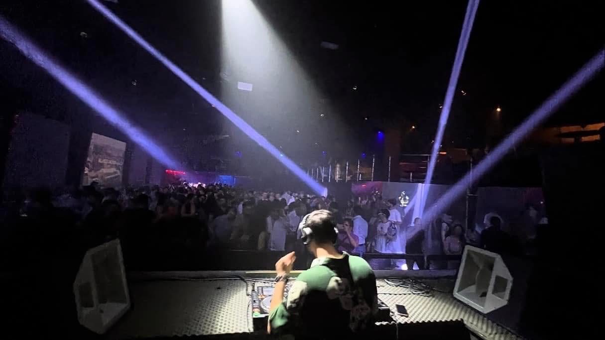 Beams sweeping the room from the booth