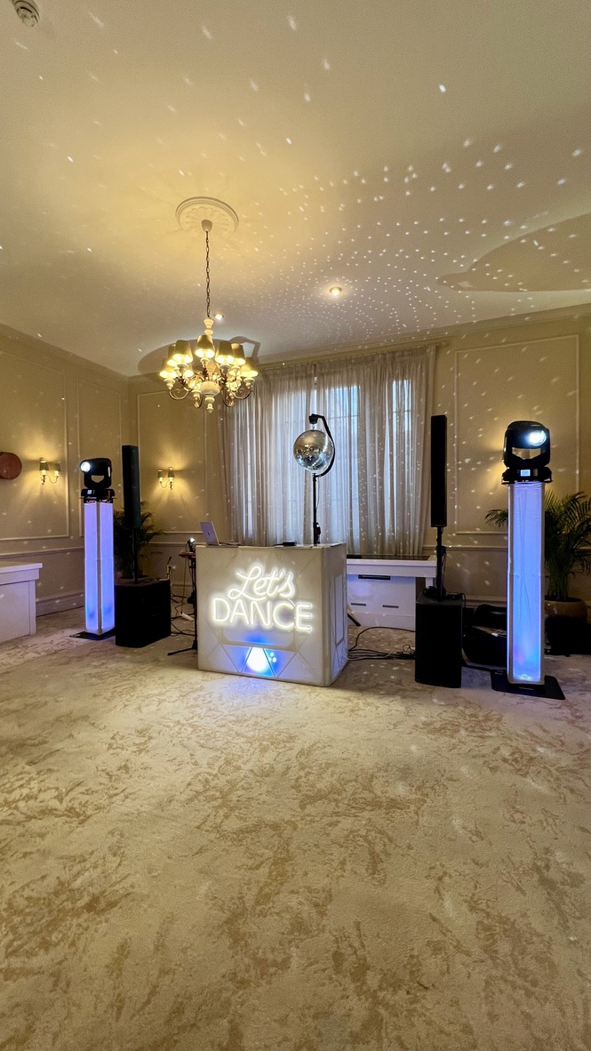 Let’s Dance booth with moving heads and mirror ball in a cream ballroom