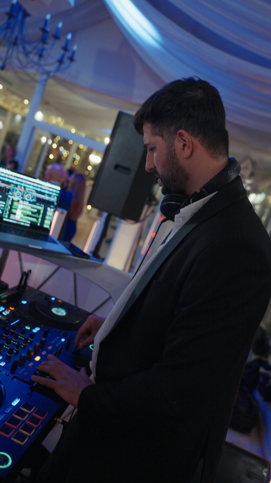Black tie DJ set beneath a draped ceiling