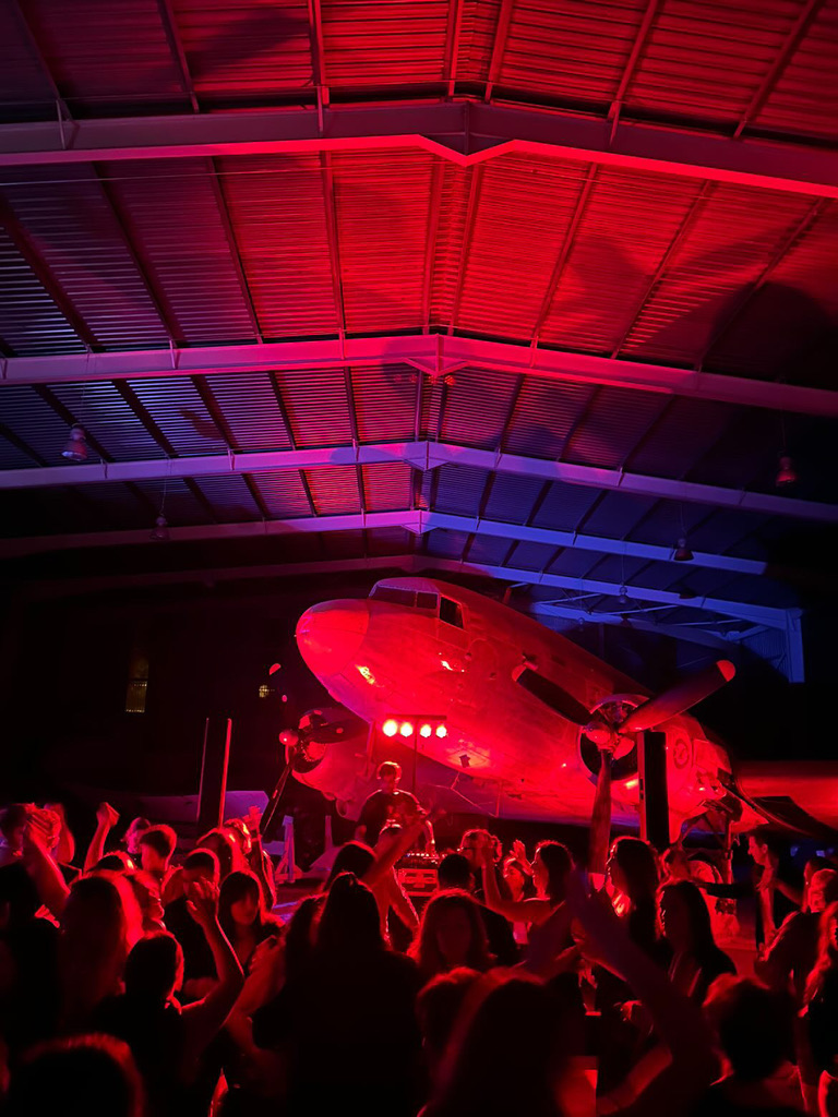 Packed hangar floor under red wash