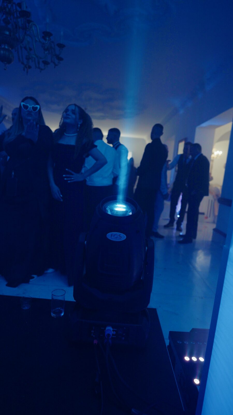 FOS moving head beaming blue across a private party floor