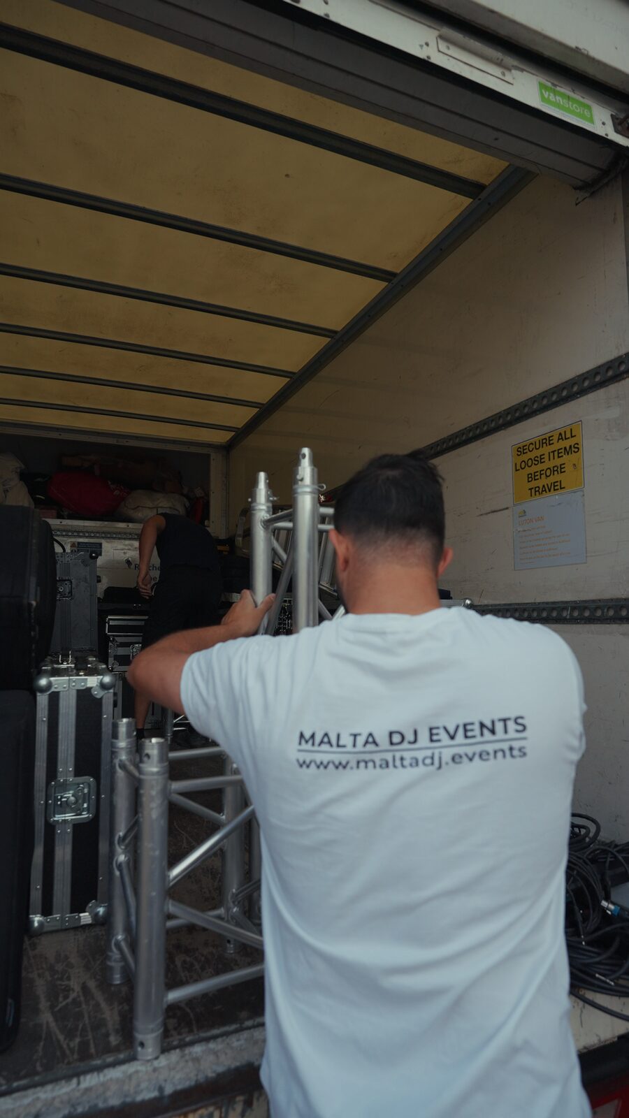 Crew loading truss into the van