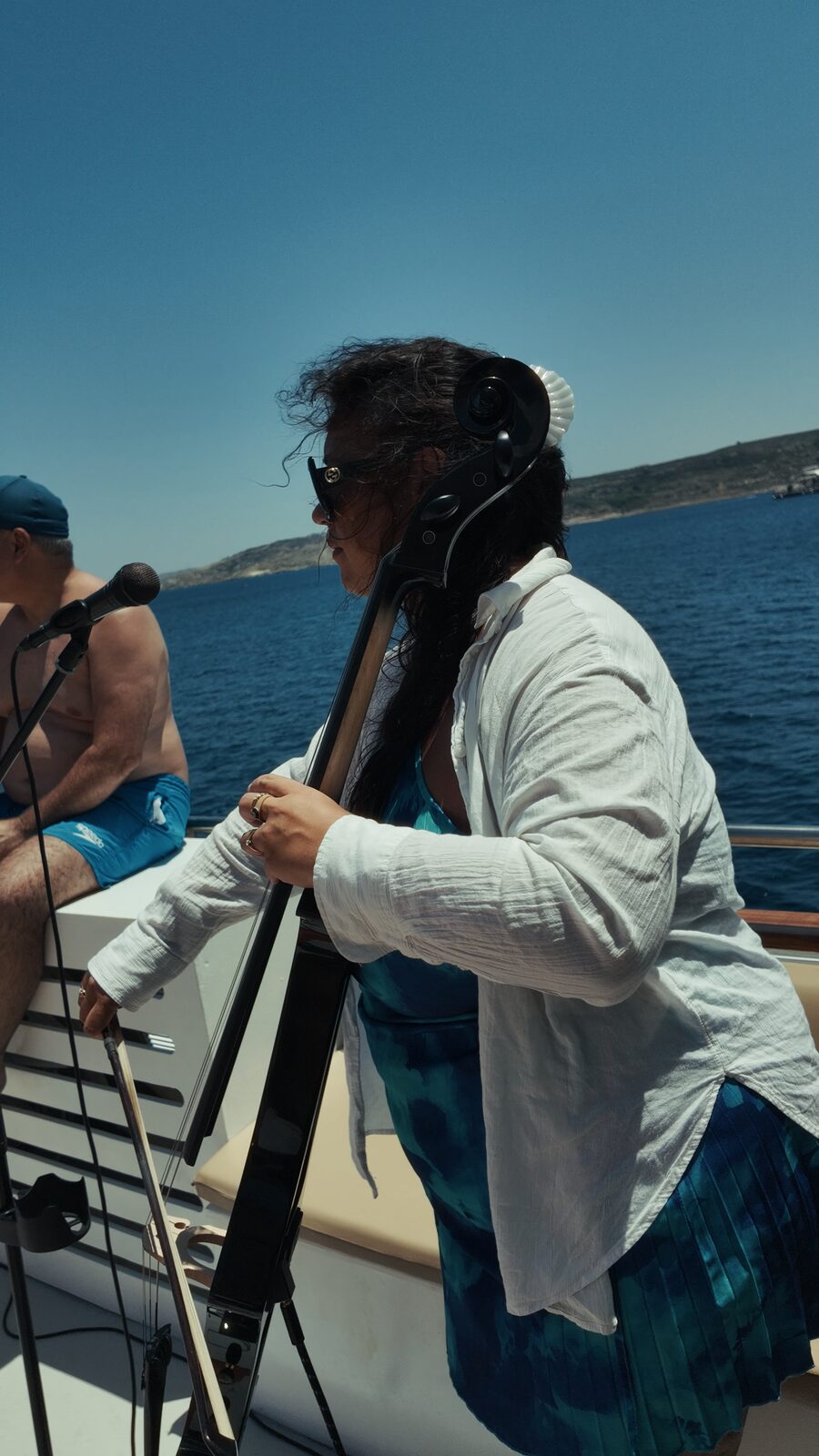 DJ leaning into the crowd mid set on the boat party
