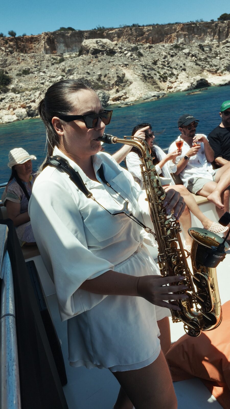 Cellist playing on deck with the Blue Lagoon behind