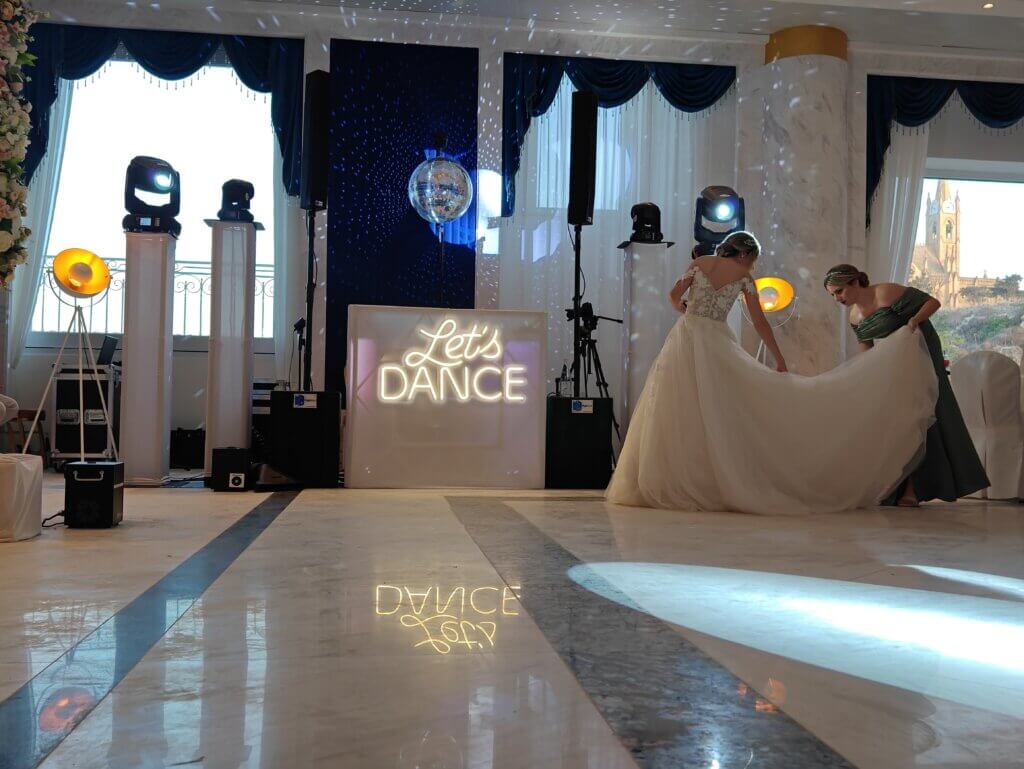 Gold Package - DJ up to 5 hours, Saxophonist - up to 2 hours, Professional Martin Audio Sound System: x2 Subwoofers, x2 Speakers, DJ monitor speaker, x1 Wireless Microphone for speeches/announcements, Lighting: x8 Battery operated uplighters, x2 Moving heads on trusses (white covers), Let’s Dance Sign, Pioneer DJ Equipment (DJ Decks), DJ Stand (with white cover option), Backup Equipment